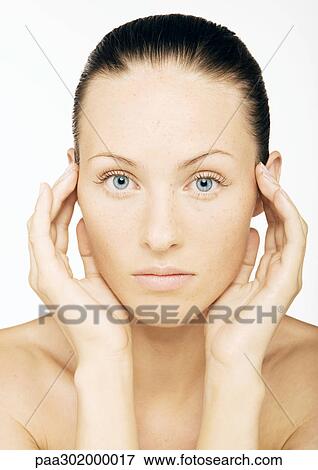 Woman's face with hands at side of head, portrait View Large Photo Image Stock Photo - Woman's face with hands at side of head, portrait. Fotosearch