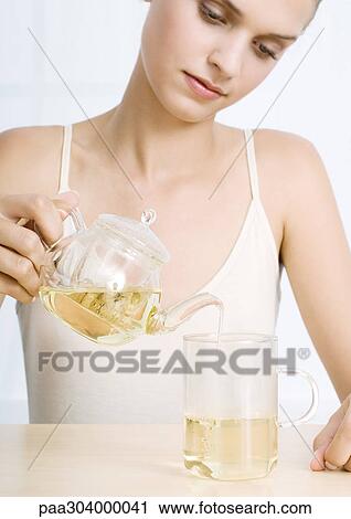 Woman pouring tea View Large Photo Image Stock Image - Woman pouring tea. Fotosearch