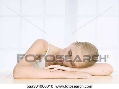 Woman resting head on arms View Large Photo Image Stock Image - Woman resting head on arms. Fotosearch