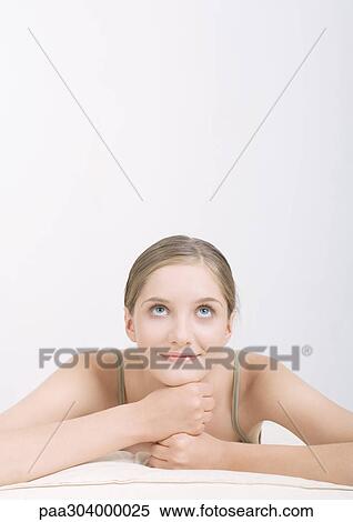 Woman resting head on hands, looking up View Large Photo Image Stock Photography - Woman resting head on hands, looking up . Fotosearch