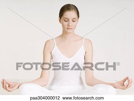 Woman sitting in lotus position View Large Photo Image Stock Image - Woman sitting in lotus position. Fotosearch