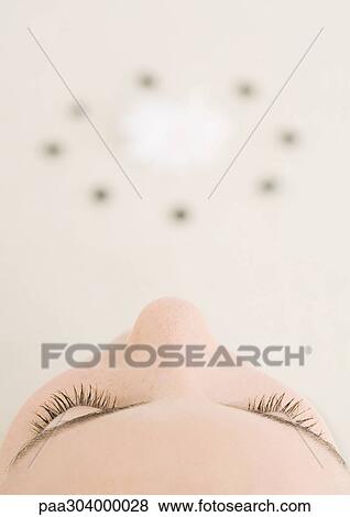 Woman's face, high angle view, and circle in blurred background View Large Photo Image Stock Photo - Woman's face, high angle view, and circle in blurred background. Fotosearch