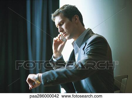 Businessman checking watch View Large Photo Image Stock Image - Businessman checking watch. Fotosearch