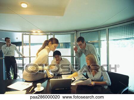 Businesspeople working in conference room View Large Photo Image Stock Image - Businesspeople working in conference room. Fotosearch