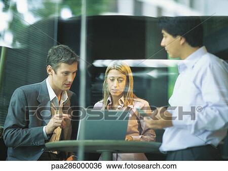 Businesspeopleng at cafe table, using laptop View Large Photo Image Stock Photograph - Businesspeopleng at cafe table, using laptop. Fotosearch