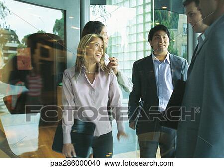 Group of businesspeople standing in front of store window View Large Photo Image Stock Image - Group of businesspeople standing in front of store window. Fotosearch