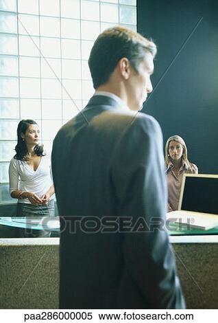 Man and two women in office View Large Photo Image Stock Photography - Man and two women in office. Fotosearch