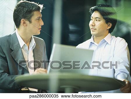 Two businessman staring at each other View Large Photo Image Stock Photography - Two businessman staring at each other. Fotosearch