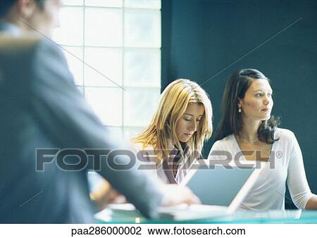 Two women and man in office View Large Photo Image Stock Image - Two women and man in office. Fotosearch