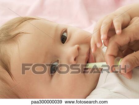 Stock Photo - Baby being medicated. Fotosearch