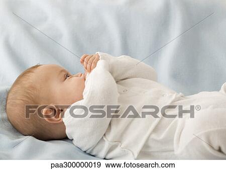 Stock Photo - Baby boy lying on back. Fotosearch