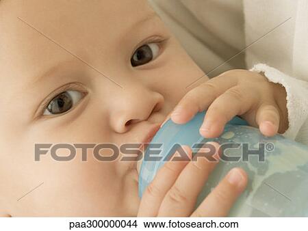 Baby drinking from bottle View Large Photo Image Picture - Baby drinking from bottle. Fotosearch