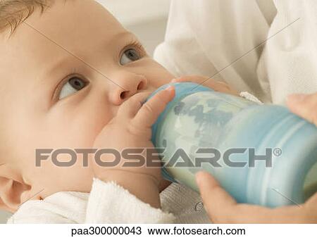 Baby drinking from bottle View Large Photo Image Stock Image - Baby drinking from bottle. Fotosearch