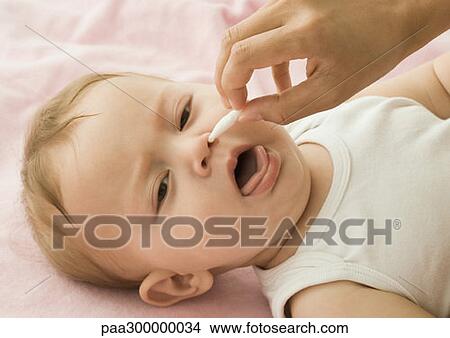 Baby having nose cleaned View Large Photo Image Picture - Baby having nose cleaned. Fotosearch