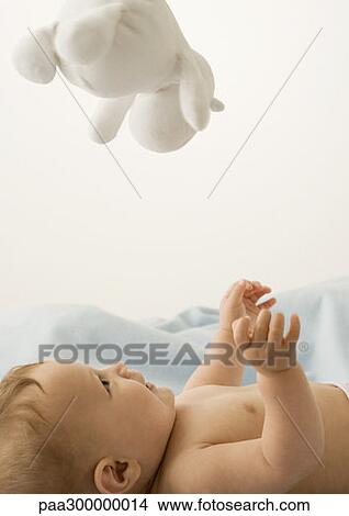 Baby looking up at toy View Large Photo Image Picture - Baby looking up at toy. Fotosearch