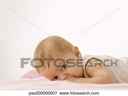 Stock Photo - Baby lying on stomach. Fotosearch