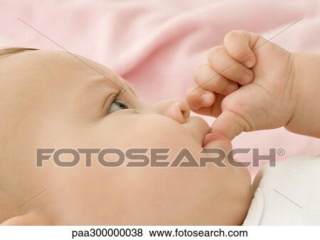 Baby sucking thumb, close-up View Large Photo Image Stock Photo - Baby sucking thumb, close-up. Fotosearch