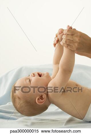 Stock Photography - Picking up baby. Fotosearch