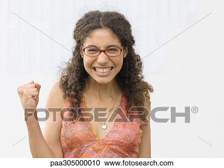 Student making fist and smiling, in front of results on wall View Large Photo Image Stock Image - Student making fist and smiling, in front of results on wall. Fotosearch