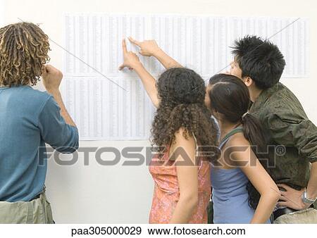 Students looking and pointing at results posted on wall, rear view View Large Photo Image Stock Photo - Students looking and pointing at results posted on wall, rear view. Fotosearch