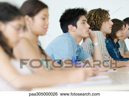Students sitting side by side attentively in class View Large Photo Image Stock Photograph - Students sitting side by side attentively in class. Fotosearch