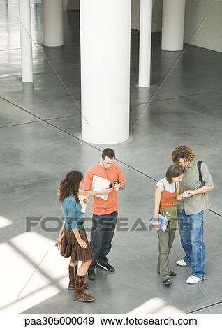 Students standing in lobby talking View Large Photo Image Stock Photo - Students standing in lobby talking. Fotosearch