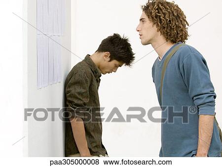 Two students standing near results posted on wall View Large Photo Image Stock Photo - Two students standing near results posted on wall. Fotosearch