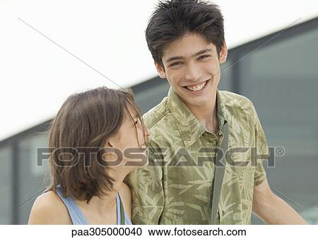 Young man and young woman laughing View Large Photo Image Stock Image - Young man and young woman laughing. Fotosearch
