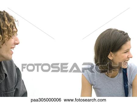 Young man and young woman smiling View Large Photo Image Stock Photograph - Young man and young woman smiling. Fotosearch