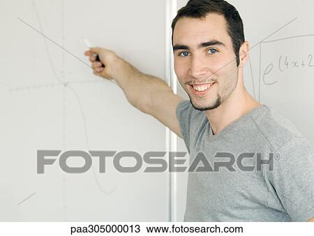 Young man writing on whiteboard View Large Photo Image Stock Image - Young man writing on whiteboard. Fotosearch