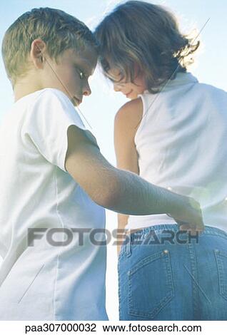 Boy pulling on girl's belt loop View Large Photo Image Stock Image - Boy pulling on girl's belt loop. Fotosearch