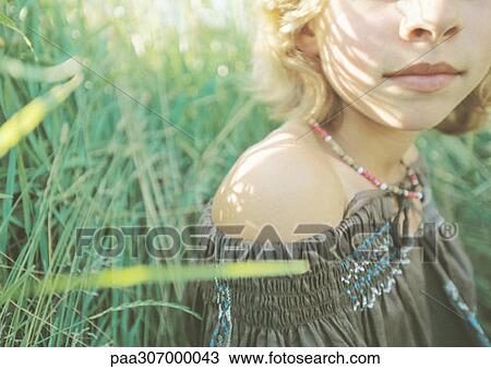 Girl sitting in grass View Large Photo Image Stock Image - Girl sitting in grass. Fotosearch