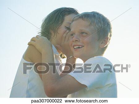 Girl whispering to boy View Large Photo Image Stock Image - Girl whispering to boy. Fotosearch