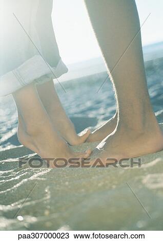 Teenage couple, girl standing on tiptoes, close-up of lower legs and feet View Large Photo Image Stock Image - Teenage couple, girl standing on tiptoes, close-up of lower legs and feet. Fotosearch