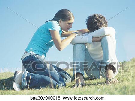 Teenage couple, girl trying to talk to boy with head down View Large Photo Image Stock Photo - Teenage couple, girl trying to talk to boy with head down. Fotosearch
