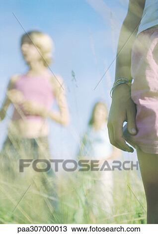 Three youngsters standing in grass View Large Photo Image Stock Image - Three youngsters standing in grass. Fotosearch