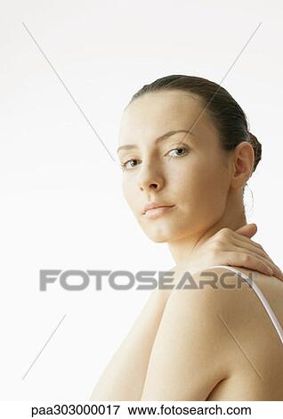 Woman with hand on back View Large Photo Image Stock Photo - Woman with hand on back. Fotosearch