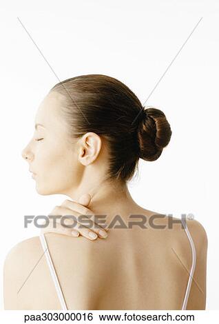 Stock Photograph - Woman with hand on back. Fotosearch