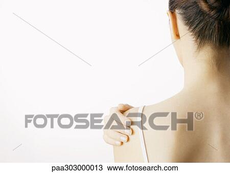 Woman with hand on shoulder, rear view View Large Photo Image Stock Image - Woman with hand on shoulder, rear view. Fotosearch