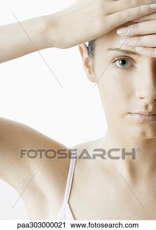 Stock Image - Woman with hands on forehead. Fotosearch