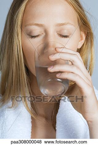 Woman drinking glass of water View Large Photo Image Stock Photo - Woman drinking glass of water. Fotosearch