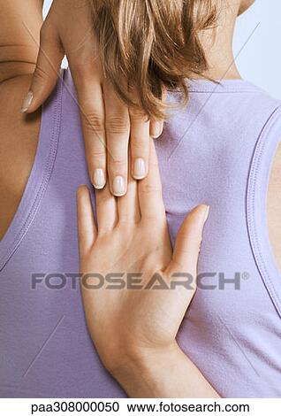 Woman touching hands behind back, close-up View Large Photo Image Stock Image - Woman touching hands behind back, close-up. Fotosearch