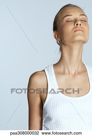 Stock Image - Woman with eyes closed and head back. Fotosearch