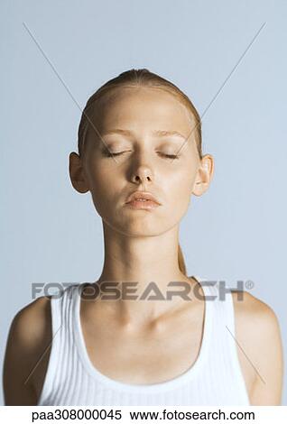 Stock Photography - Woman with eyes closed wearing tank top, portrait. Fotosearch