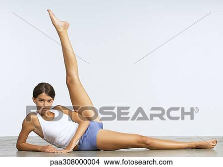 Young woman doing leg lifts View Large Photo Image Picture - Young woman doing leg lifts. Fotosearch