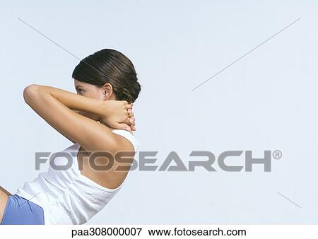 Young woman doing sit-ups View Large Photo Image Stock Photo - Young woman doing sit-ups. Fotosearch
