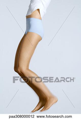 Young woman jumping, chest down View Large Photo Image Stock Image - Young woman jumping, chest down. Fotosearch