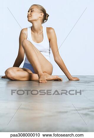 Young woman sitting on floor with eyes closed View Large Photo Image Stock Image - Young woman sitting on floor with eyes closed. Fotosearch