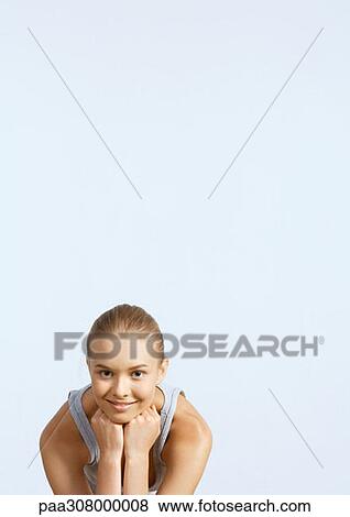Young woman smiling, leaning head on hands View Large Photo Image Stock Photo - Young woman smiling, leaning head on hands. Fotosearch