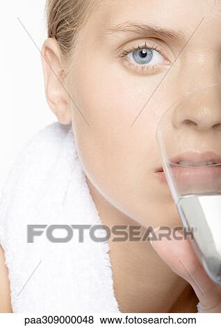 Young woman drinking glass of water View Large Photo Image Stock Photo - Young woman drinking glass of water. Fotosearch